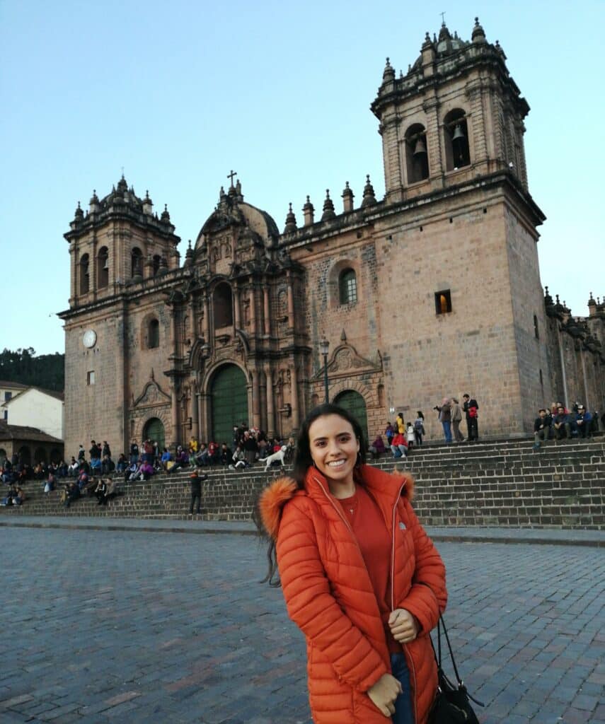 The picture shows Liza in an orange coat, standing in front of the cathedral in the Plaza de Armas in Santiago de Chile.